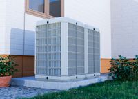 Outdoor HVAC units installed beside a house, demonstrating modern cooling and heating solutions.